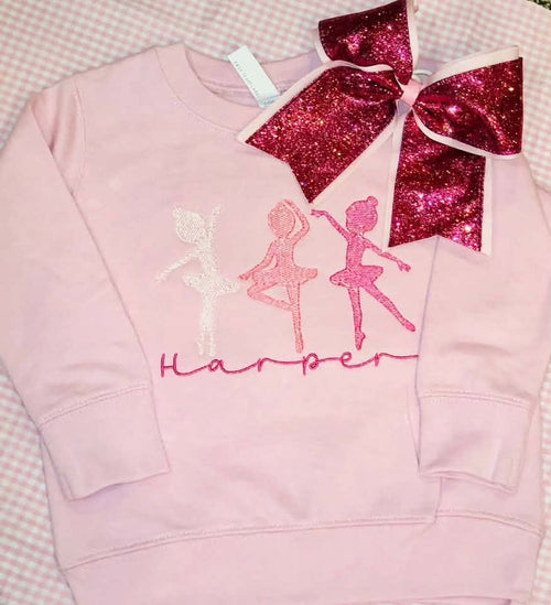 Pink ballerina sweatshirt personalized with the name Harper, pictured with a glittery bow.